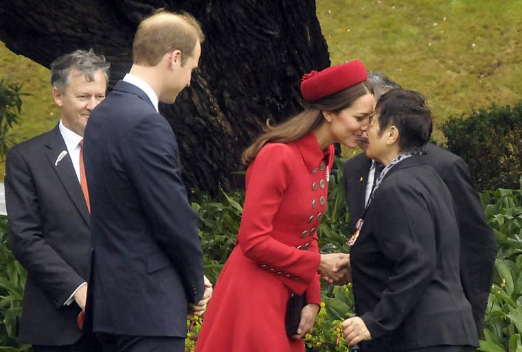Britain's Prince William (2nd L) watches as his wife Catherine, Duchess of Cambridge, receives a Maori welcome known as a 'Hongi' at a traditional Mao...