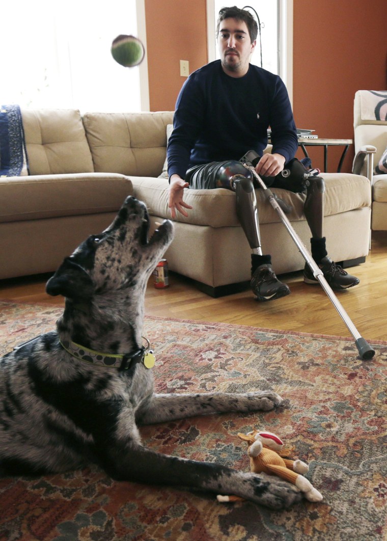 ADVANCE FOR WEEKEND USE APRIL 4-5 -- In this March 14, 2014 photo, Jeff Bauman, plays catch with his dog Bandit, at his Carlisle, Mass., home. Bauman,...