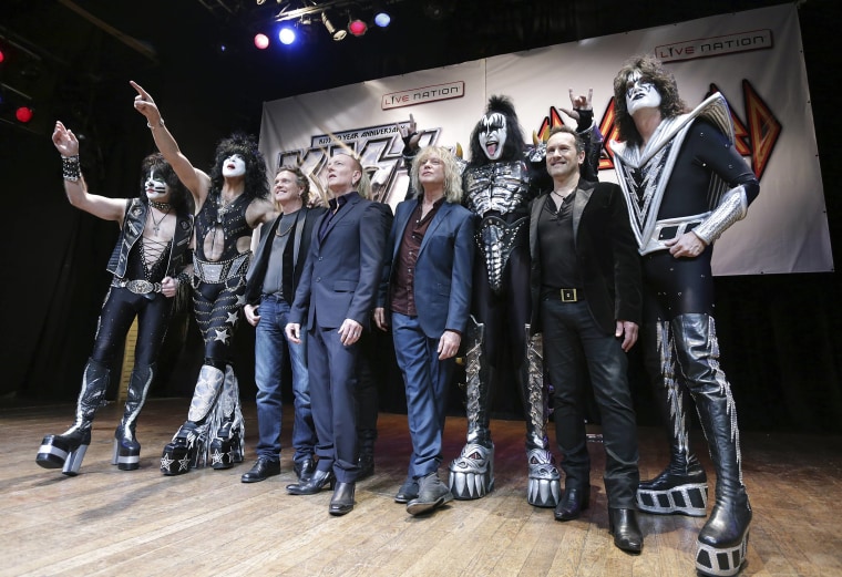 Members of KISS and Def Leppard pose during an announcement that the bands will team up this summer for a 42-city North American tour, at the House of...