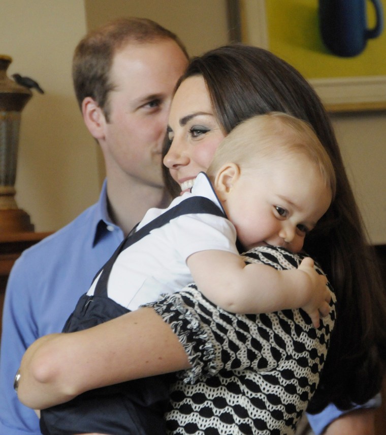 This handout photo taken on April 9, 2014 and provided by Woolf / Crown Copyright shows Britain's Prince George being held by his mother, Catherine, t...