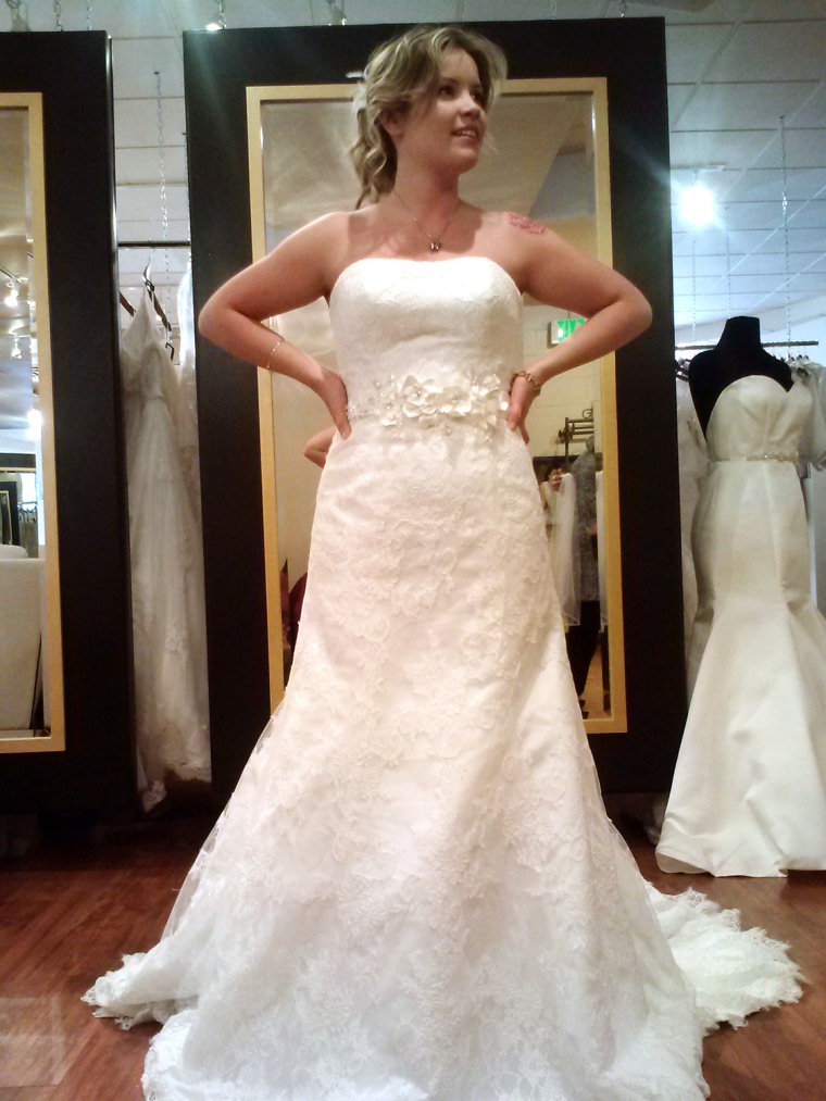 Cays tries on a wedding gown she eventually purchased, and had stolen.