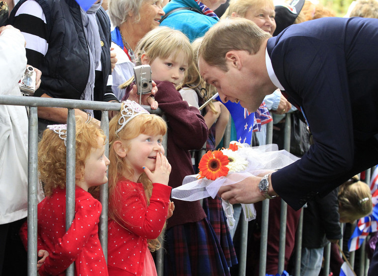 TOPSHOTS

Britain's Prince William (R) receives flowers from three-year-old twins Lola and Milly Barnett  during a walkabout in Seymour Square during ...
