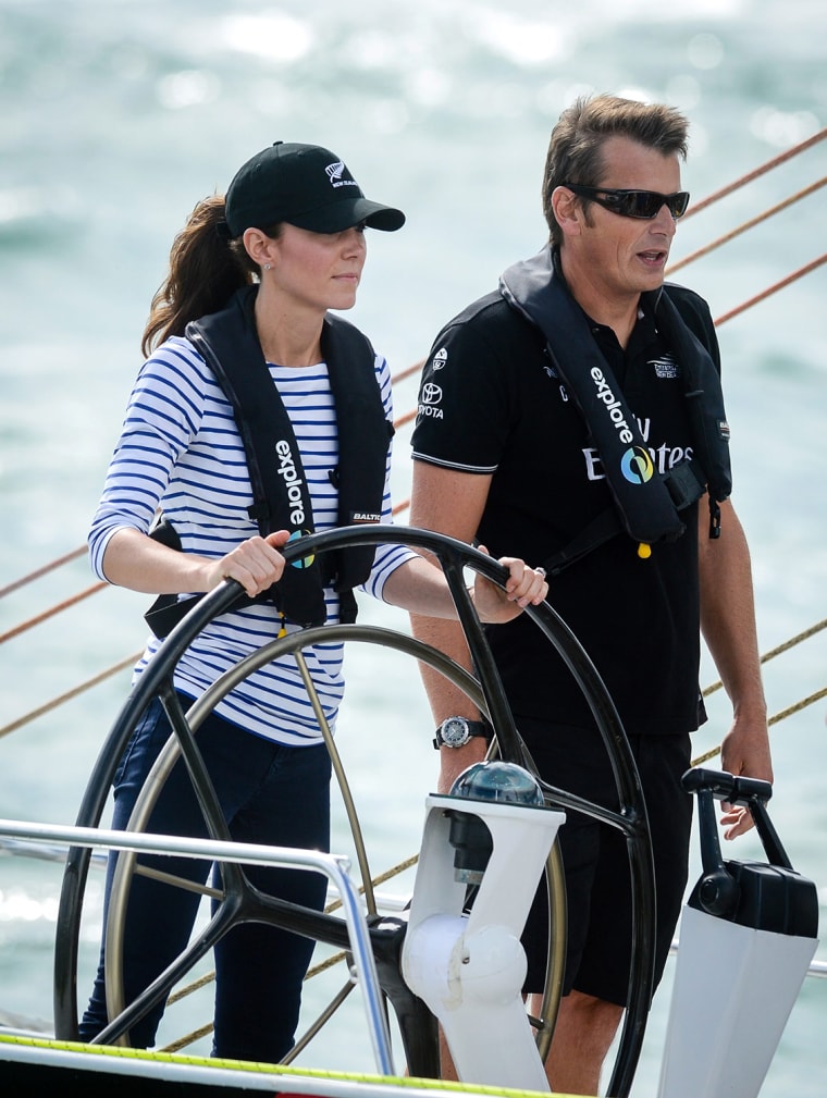 epa04162916 Britain's Catherine, Duchess of Cambridge (L), steers an Americas Cup yacht under the guidance of Team New Zealand skipper Dean Barker (R)...