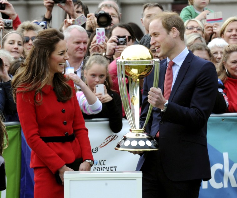 Prince William holds the Cricket World Cup trophy as Duchess Kate  smiles during a promotional event at Latimer Square during their visit to Christchurch, New Zealand, on Monday.