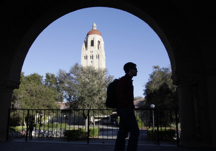 FILE - In this Feb. 15, 2012 file photo, a Stanford University student walks in front of Hoover Tower on the Stanford University campus in Palo Alto, ...