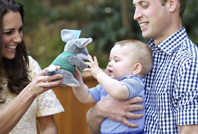 Prince William holds Prince George as Catherine, Duchess of Cambridge, gives him a toy during a visit to the Bilby Enclosure at Sydney's Taronga Zoo A...