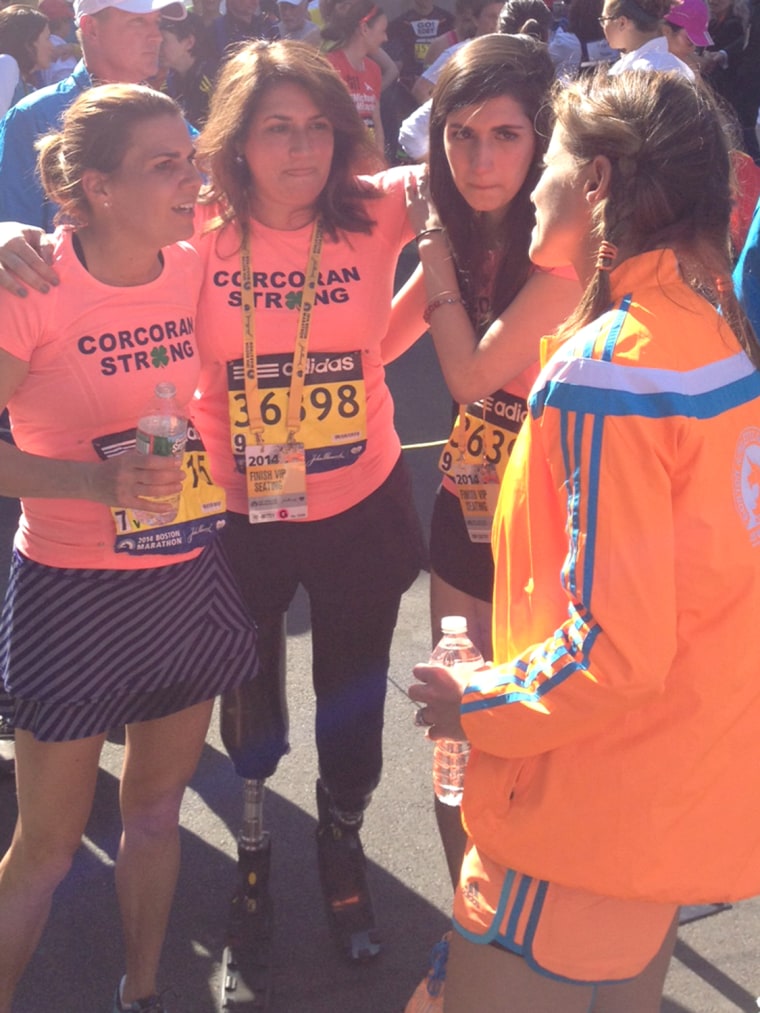Celeste and Sydney Corcoran joined Carmen Acabbo at the finish line for the Boston Marathon on Monday, a year after the bombing that claimed both of Celeste's legs and left them with injuries.