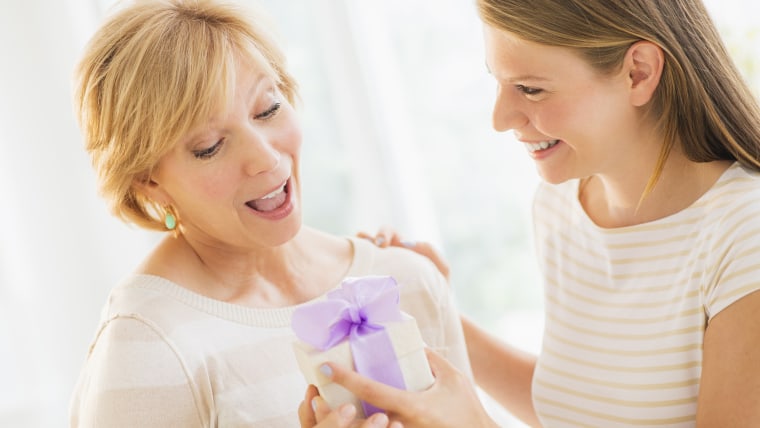 Adult daughter giving present to mother