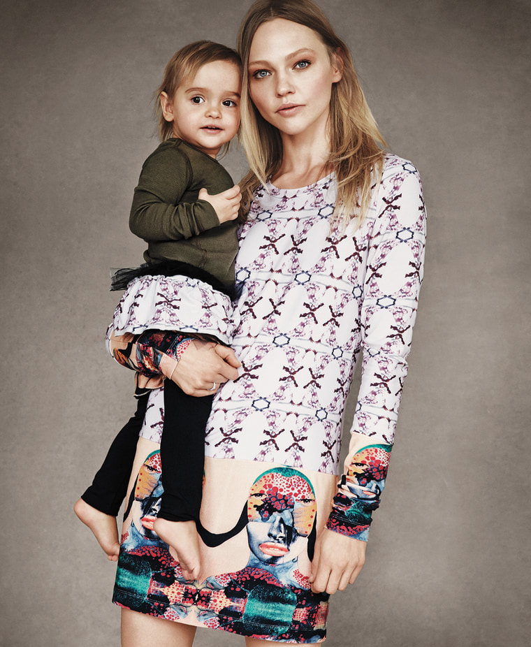 Sasha Pivovarova holding her daughter, Mia, dressed in coordinated outfits by Victoria Beckham for Born Free.