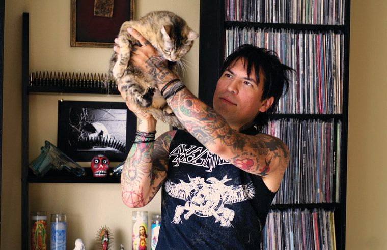 Photo of Dav Tafoya and Ghidora the cat from “Metal Cats” by Alexandra Crockett, published by powerHouse Books.