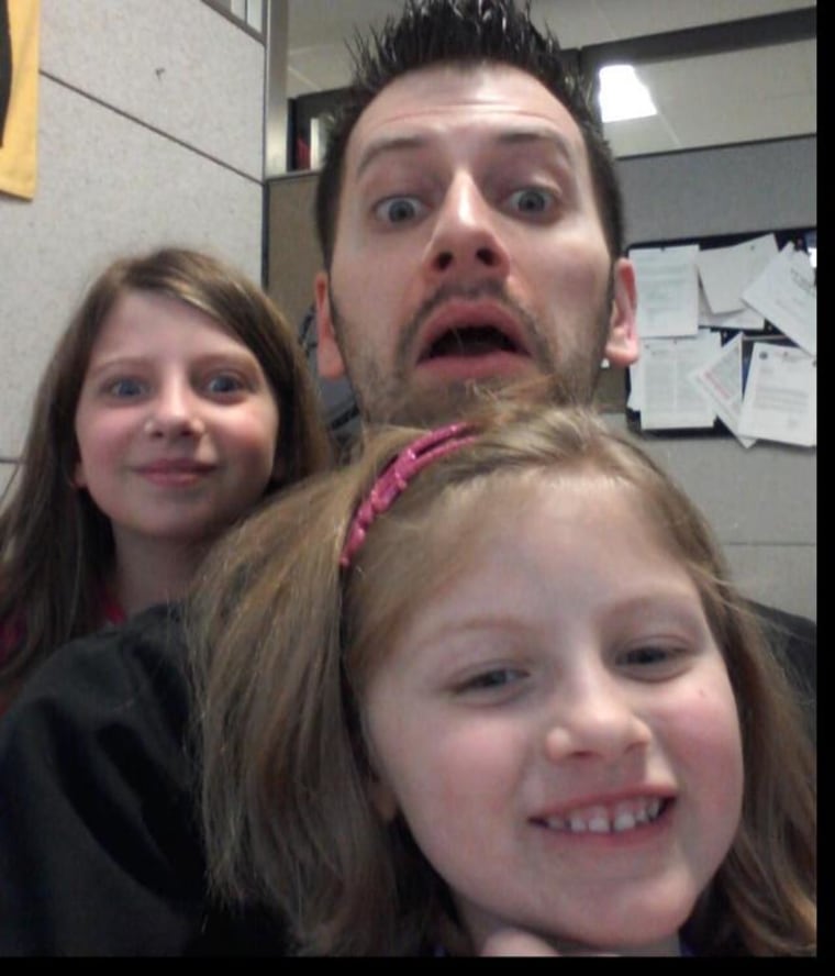 Jason Condo with his daughters at work this week.