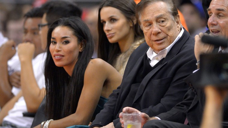 In this photo taken on Friday, Oct. 25, 2013, Los Angeles Clippers owner Donald Sterling, right, and V. Stiviano, left, watch the Clippers play the Sa...