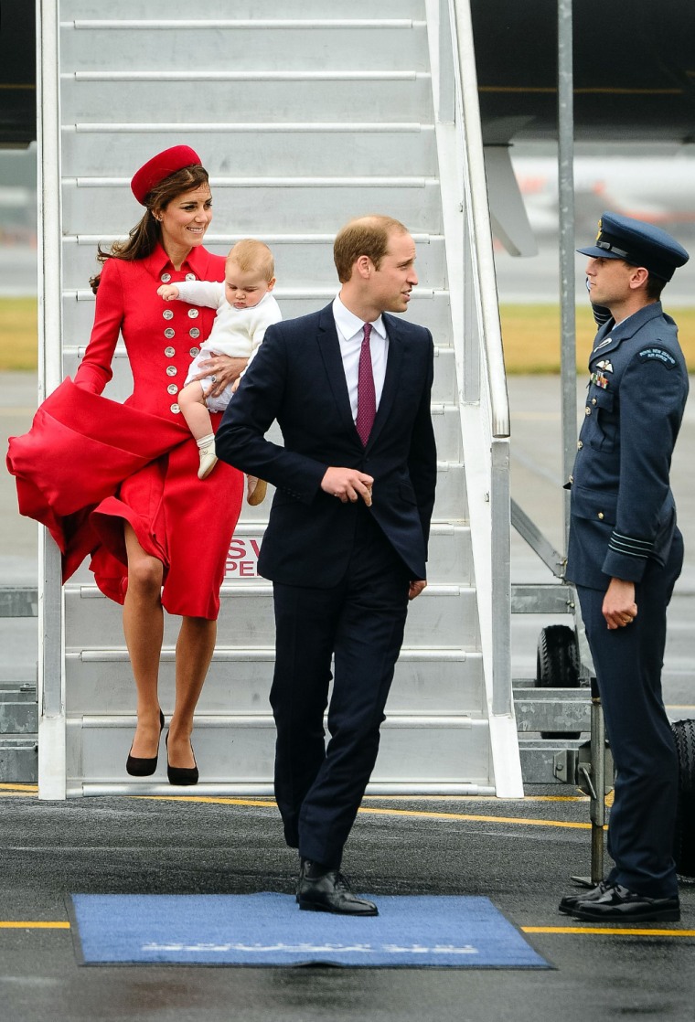 Britain's Prince William (C) and his wife Catherine (L), carrying baby Prince George arrive, at the international airport in Wellington on April 7, 20...