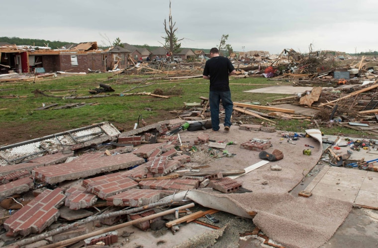 Shawn Riddle reacts while searching through the rubble of his family's home destroyed a day after a tornado hit the town of Vilonia, Arkansas April 28...