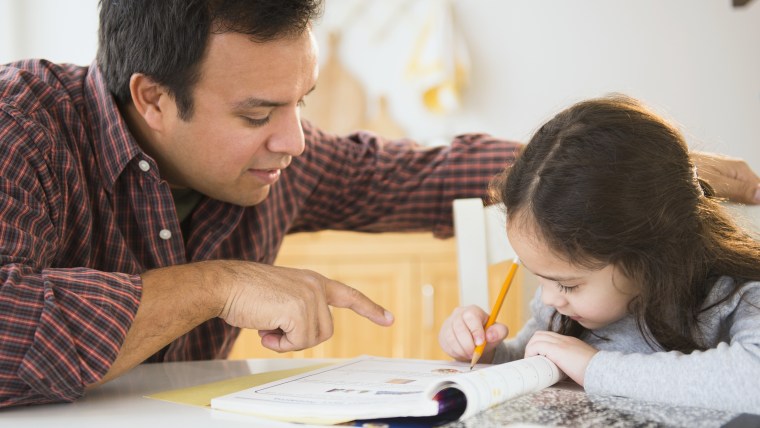 Father helping daughter with homework