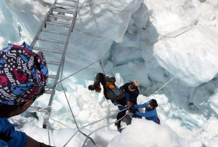 Nepalese rescue team members rescue a survivor of an avalanche on Mount Everest on April 18, 2014.  At least 12 Nepalese guides preparing routes up Mo...
