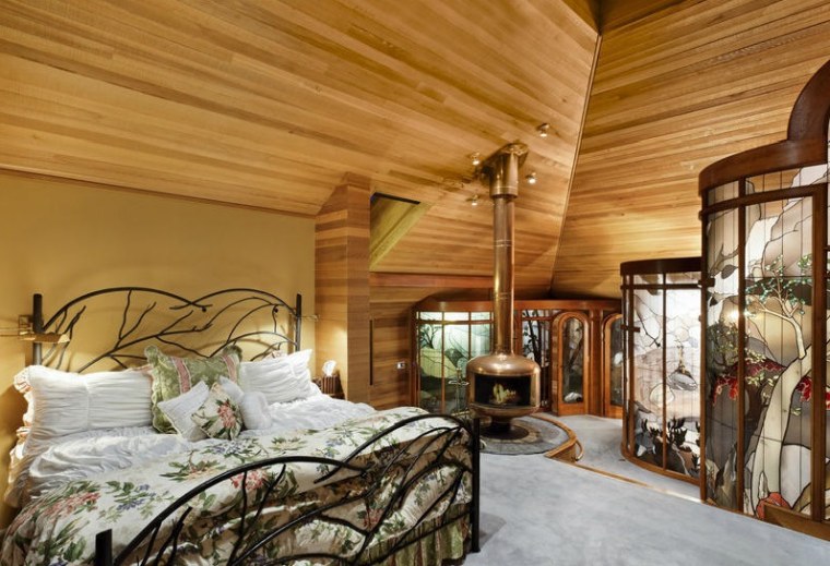 The home's master bedroom features curved stained glass walls.