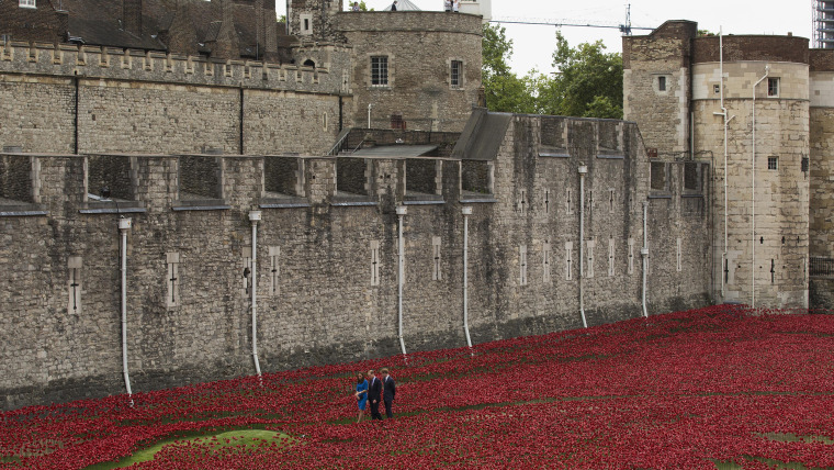 Britain's Duke of Cambridge Prince William, center, his wife Kate the Duchess of Cambridge and his brother Prince Harry visit a ceramic poppy art inst...