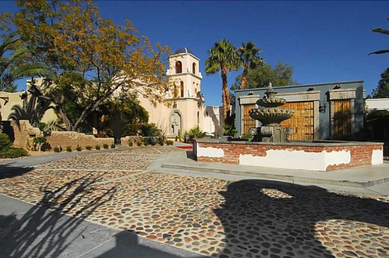 The estate covers 1.7 acres and includes a six-car garage and a Medieval chapel, and is, of course, walled in.