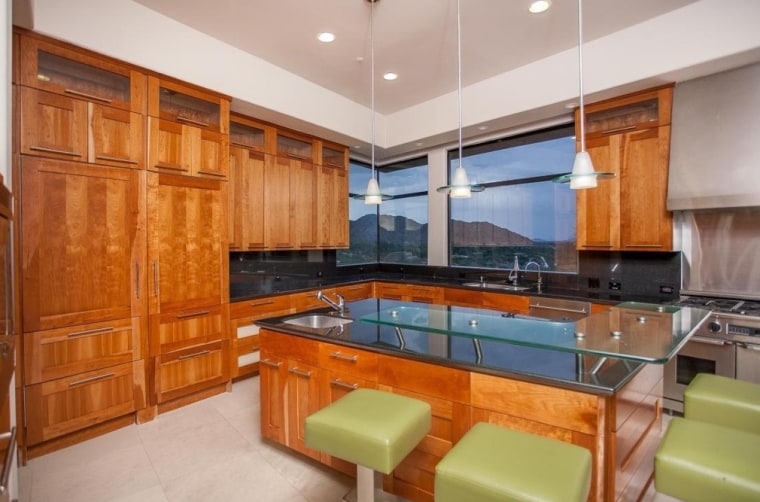 The gourmet kitchen features cherry wood, granite and glass.