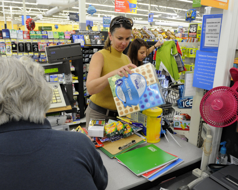 Heather Savage, with her daughter, Mallory, makes sales tax holiday purchases during the three-day tax holiday event at the Wal-Mart on Friday, Aug. 1...