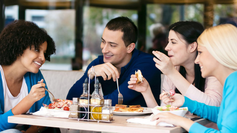 Four cheerful friends chatting while lunch in restaurant; Shutterstock ID 125612351; PO: TODAY.com