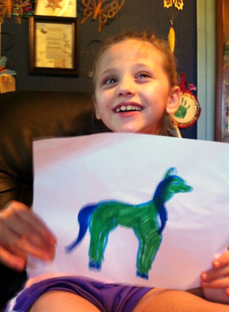 Lex with a homemade horse drawing; she has loved horses since she was 3 years old.