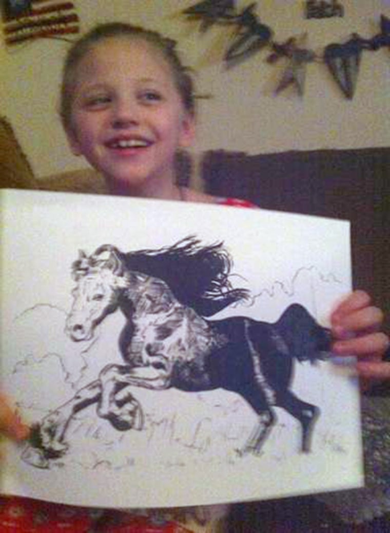 Lex with one of the many horse drawings that have arrived in the mail.