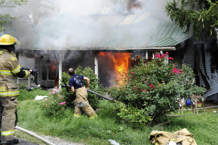 Firefighters from several Henderson County volunteer fire departments battle a house fire at 6877 Old Henderson-Spottsville Road in Spottsville, Ky. o...