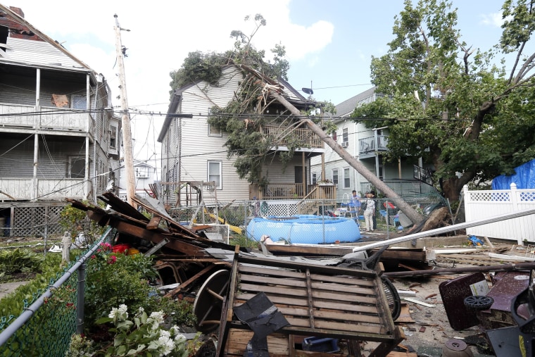 People observe the damage in the back of several houses in Revere, Mass. Monday, July 28, 2014, after a tornado touched down. Revere Deputy Fire Chief...
