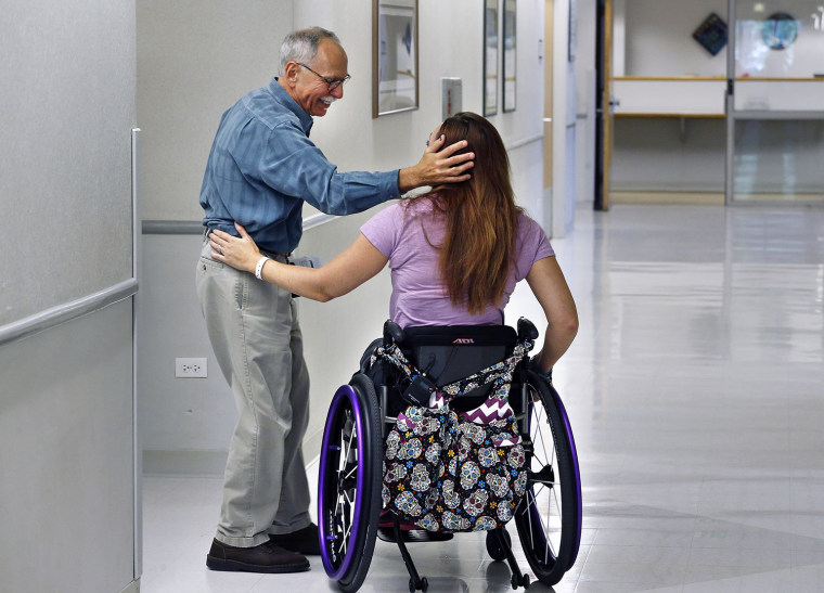 Olympic swimmer AmyÂ VanÂ Dyken-Rouen talks with Craig Hospital Director of Phychology Dr. Lester Butt  before leaving the hospital in Englewood, Colo...