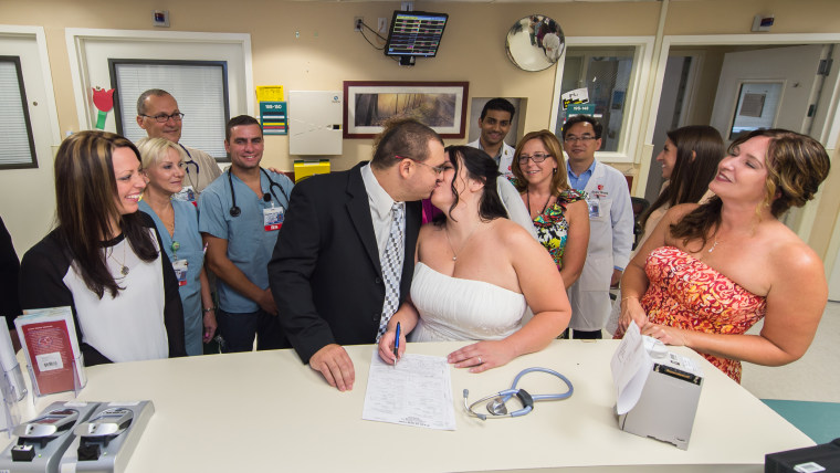 After saying their marriage vows, Lauricella and Mikucki of Holtsville signed their marriage certificate at the nurses station on the oncology/bone marrow unit.