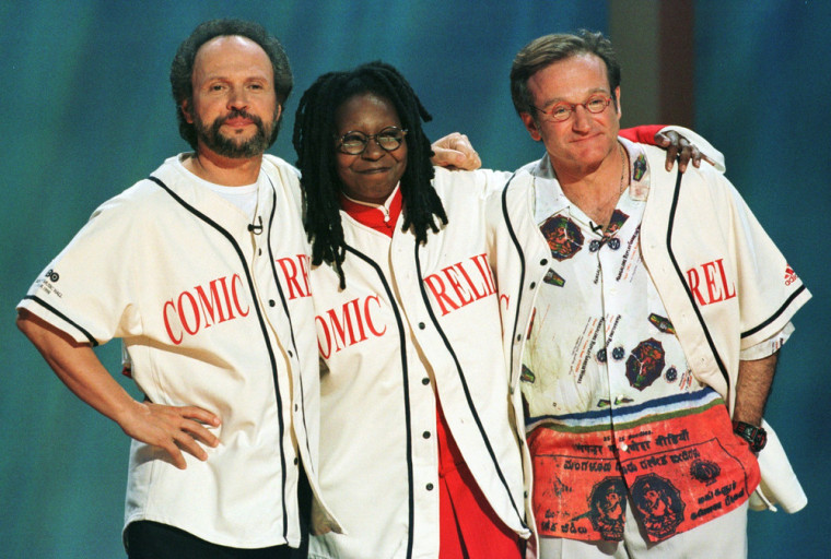 Image: Robin Williams, Billy Crystal, and Whoopi Goldberg share a hug on the stage of New York's Radio City Music Hall at the end of HBO's \"...