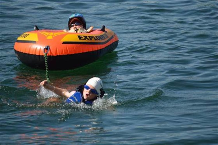 Noah pulls Lucas in a raft during the swimming portion of a triathlon.