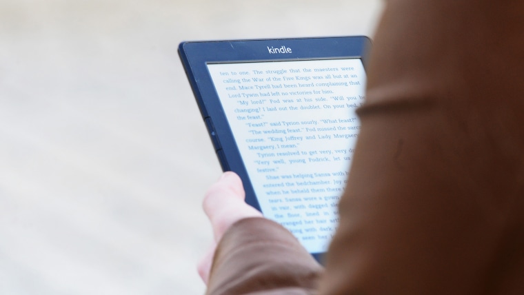 Technology stock. A generic stock photo of a woman using a Kindle, made by Amazon, in central London. Picture date: Wednesday November 19, 2014. Photo...