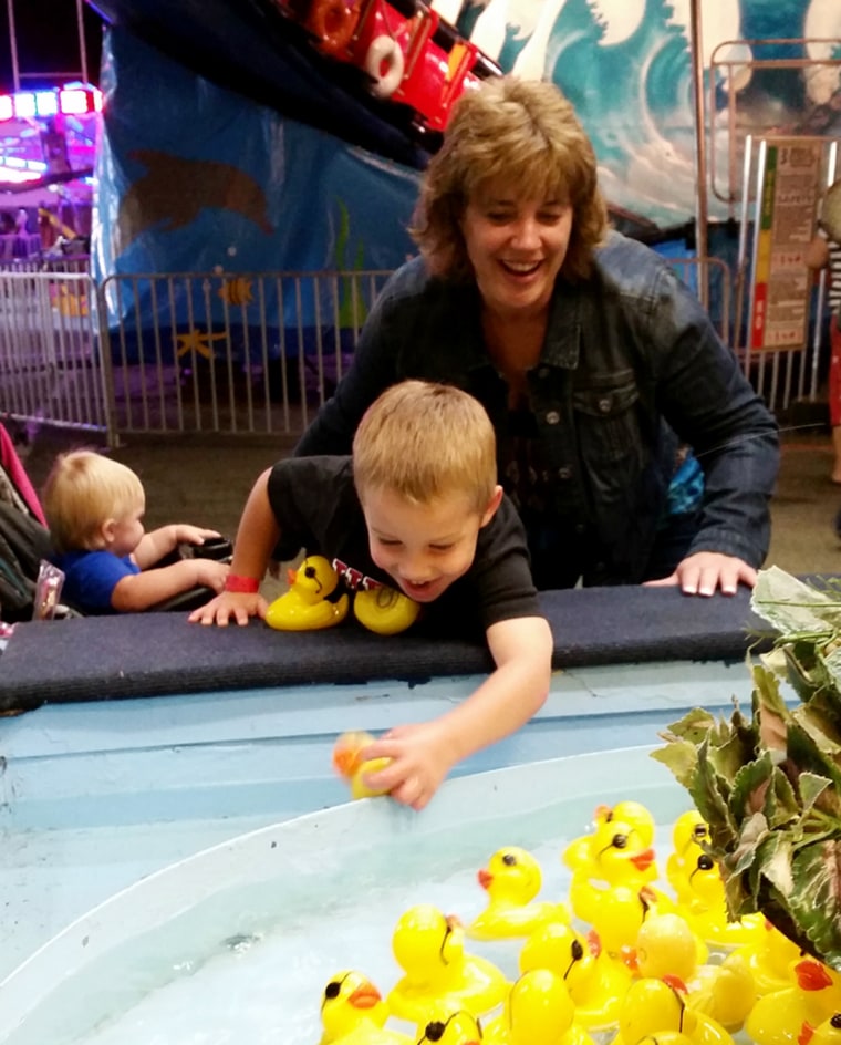 Cathy Pochek plays with her 4-year-old grandson, Gavin, at a local fair.