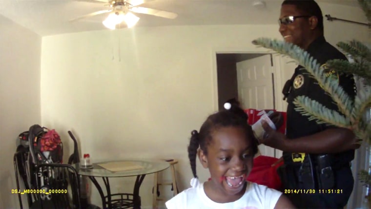 The 7-year-old girl surprised by a Christmas delivery by two Florida police officers.