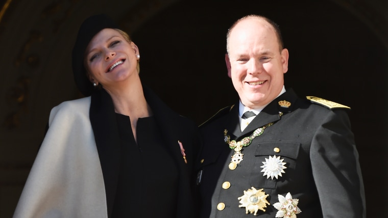 MONACO - NOVEMBER 19:  (L-R) Princess Charlene of Monaco and Prince Albert II of Monaco greet the crowd from the palace's balcony during the National ...