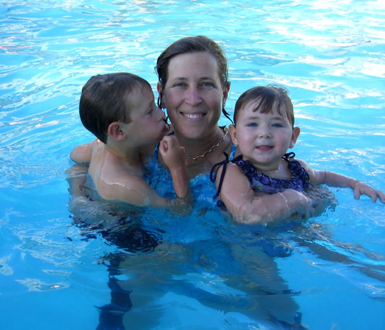 Wojcicki, pictured here with two of her four children, says that her career makes her a better mom and her family life makes her better at her work.