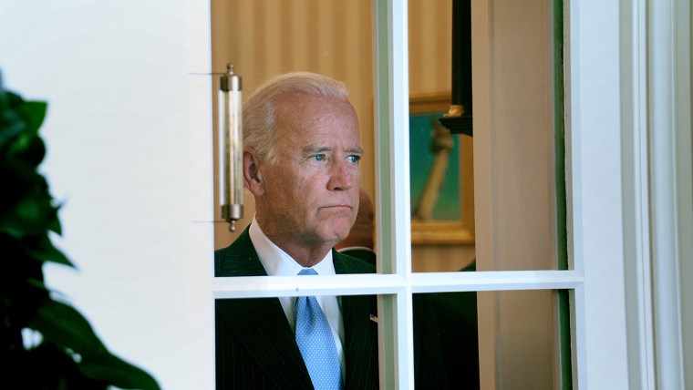 Joe Biden looking through a window