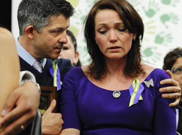 Ian and Nicole Hockley, parents of Sandy Hook School shooting victim Dylan, listen at a news conference at Edmond Town Hall in Newtown, Conn., Monday,...