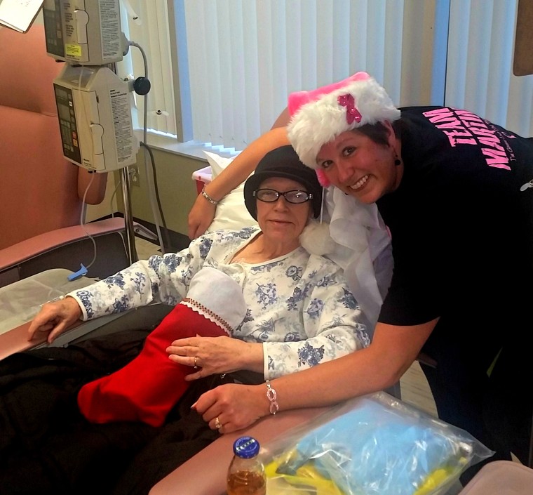 Jenifer Niederwerfer shares holiday cheer with a patient at Tennessee Oncology.