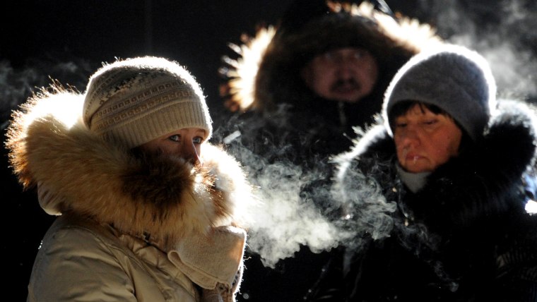 Women's frozen breath hangs in the air in central Minsk, on January 30, 2014. The temperatures in the Belarus capital dropped today to - 18 C, but due...