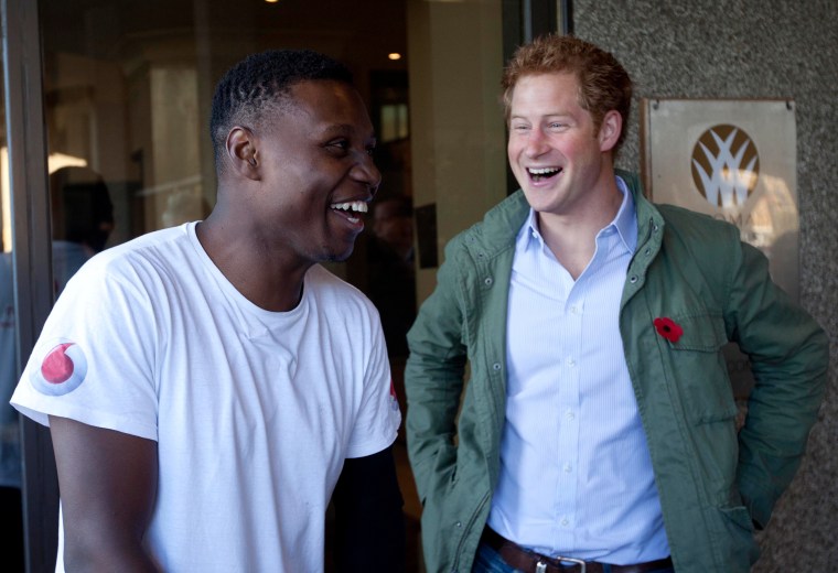 Prince Harry meets former Royal Marine Commando Ben McBean as he completes his 31-mile run through London.