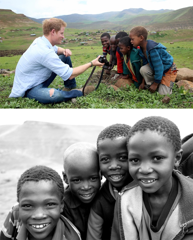 MOKHOTLONG, LESOTHO - DECEMBER 08:  Prince Harry shows children a photograph he has taken on a Fuji X100s Camera during a visit to a herd boy night sc...