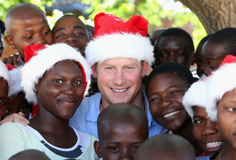 MOHALES HOEK, LESOTHO - DECEMBER 05:  Prince Harry wears a Christmas hat with orphans from the Mants'ase Children's Home during a visit on December 5,...