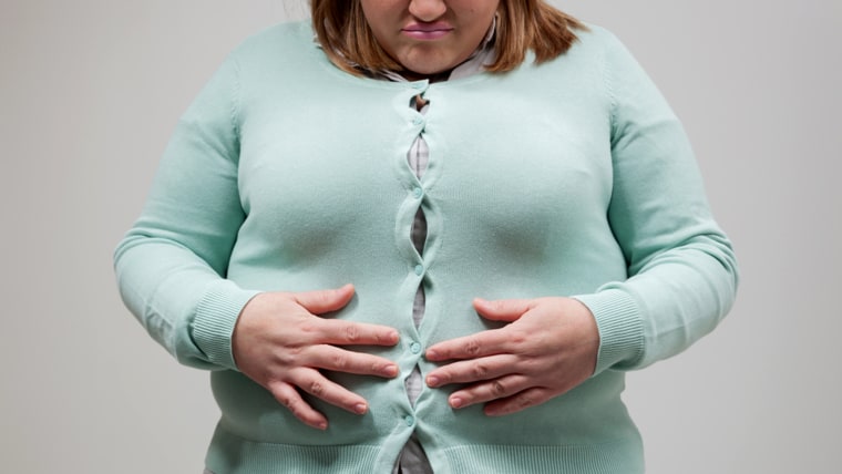 woman with tight clothing worried about weight gain.; Shutterstock ID 236665135; PO: today.com