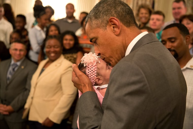 June 23, 2014
\"The President kisses a baby girl as he and the Vice President greeted wounded warriors and their families during their tour in the East...