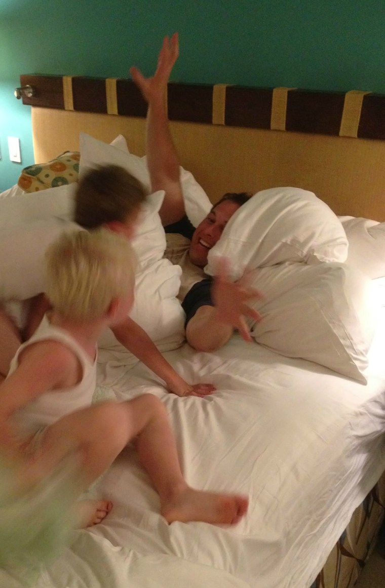 Omer Cedar has a friendly pillow fight with sons Eli and Sam.