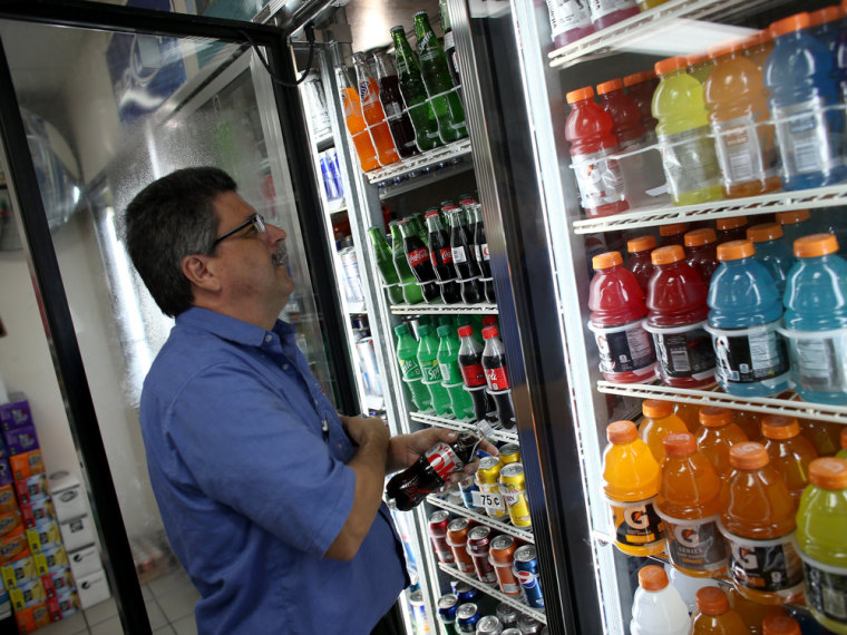 MIAMI, FL - DECEMBER 09:  Gilberto Flores stocks the shelf with Diet Coke at the Amerika convience store on December 9, 2013 in Miami, Florida. Accord...